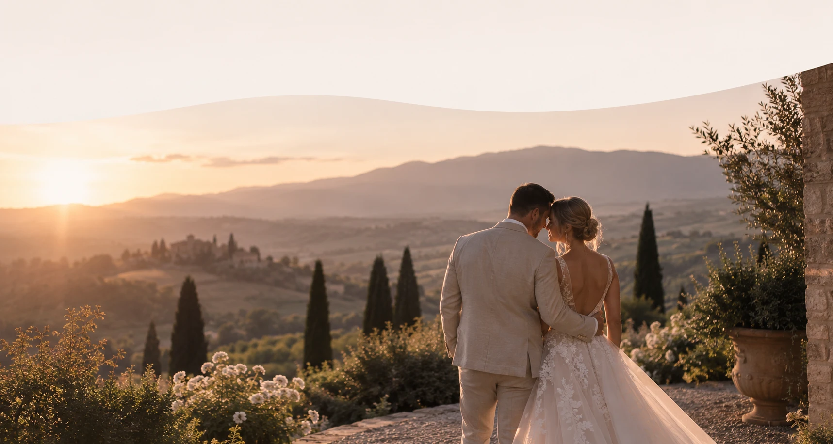 A couple overlooking a sunlit valley at golden hour