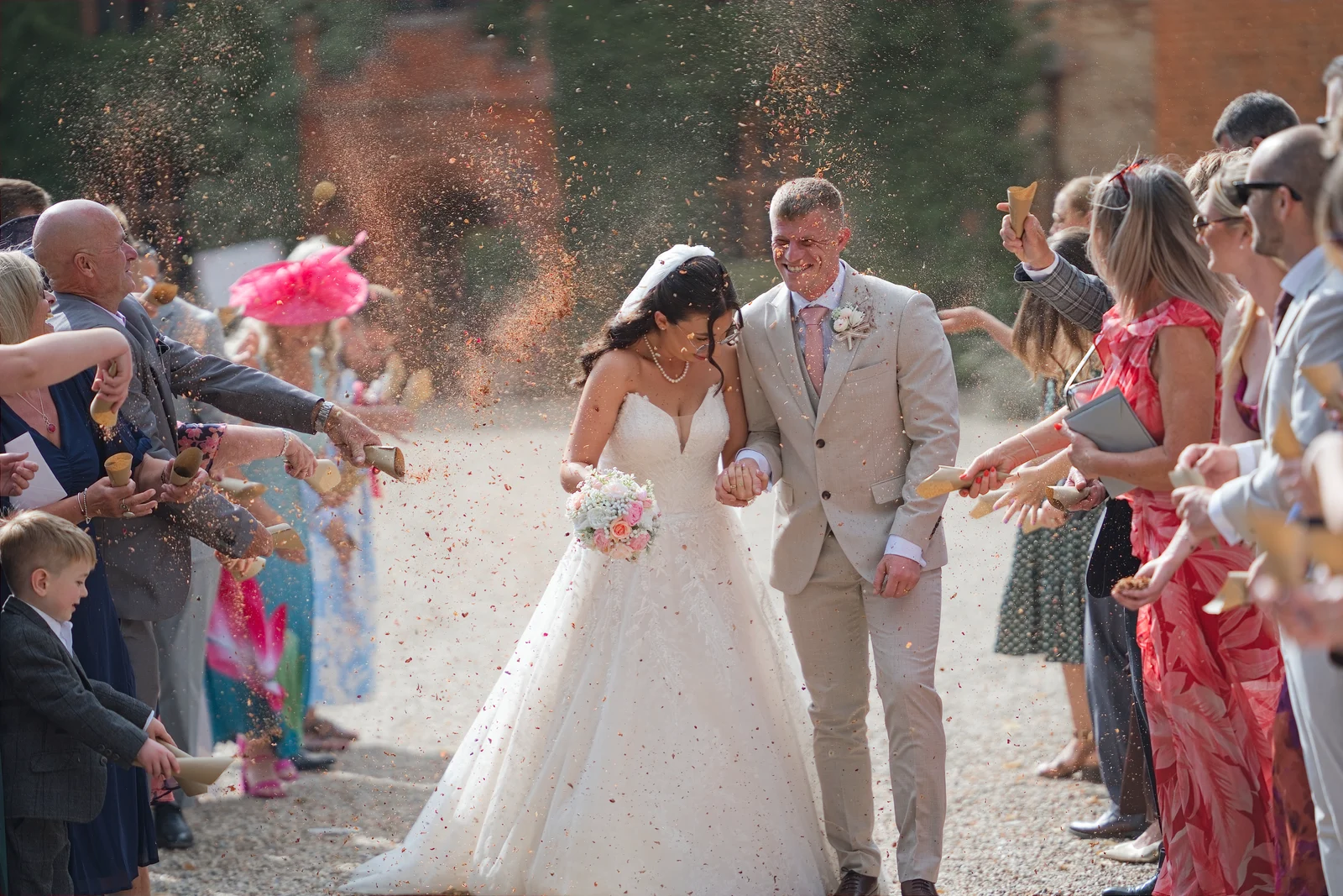 Guests throwing confetti over the newlyweds