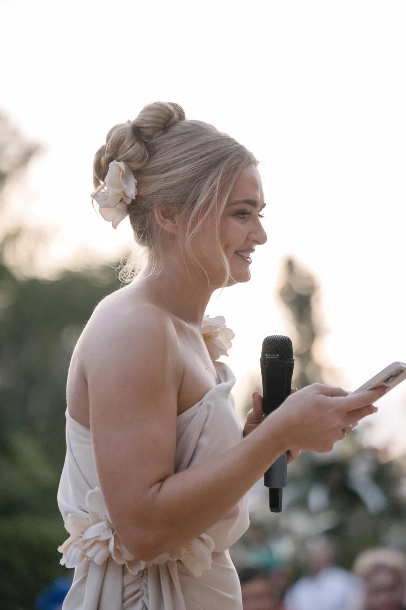 A guest laughing while giving a speech at Ellie and Ernie’s wedding