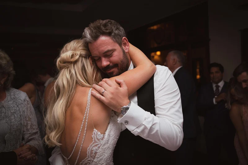 Rhea and Ben embracing on the dance floor