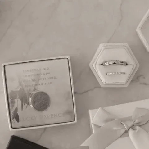 Wedding rings and a lucky sixpence laid out before the ceremony