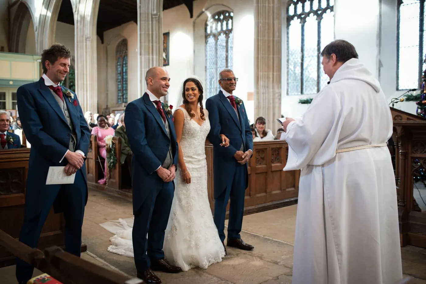 Wide view of a church wedding ceremony with the vicar