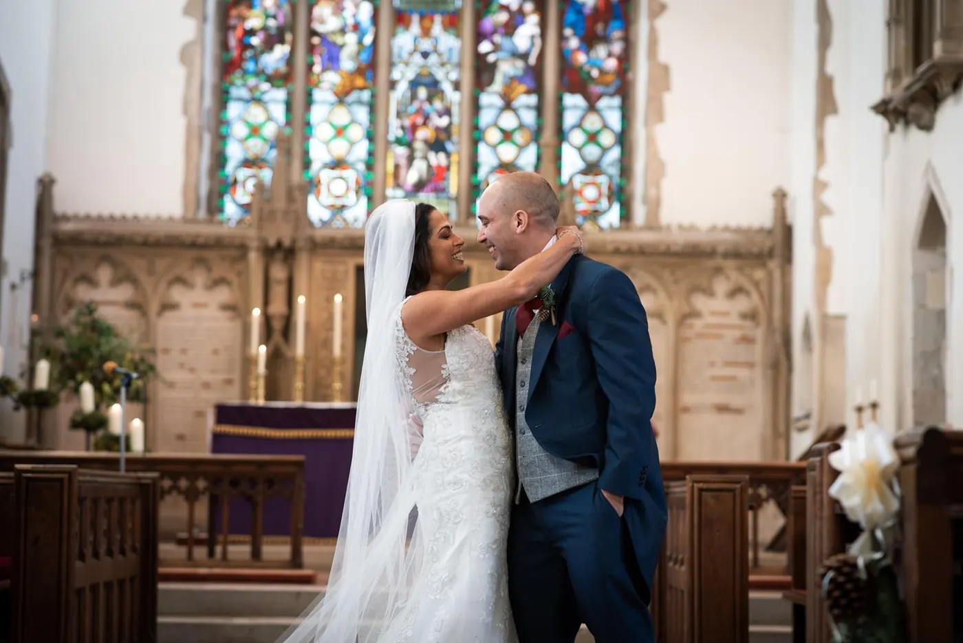First kiss in front of stained glass windows