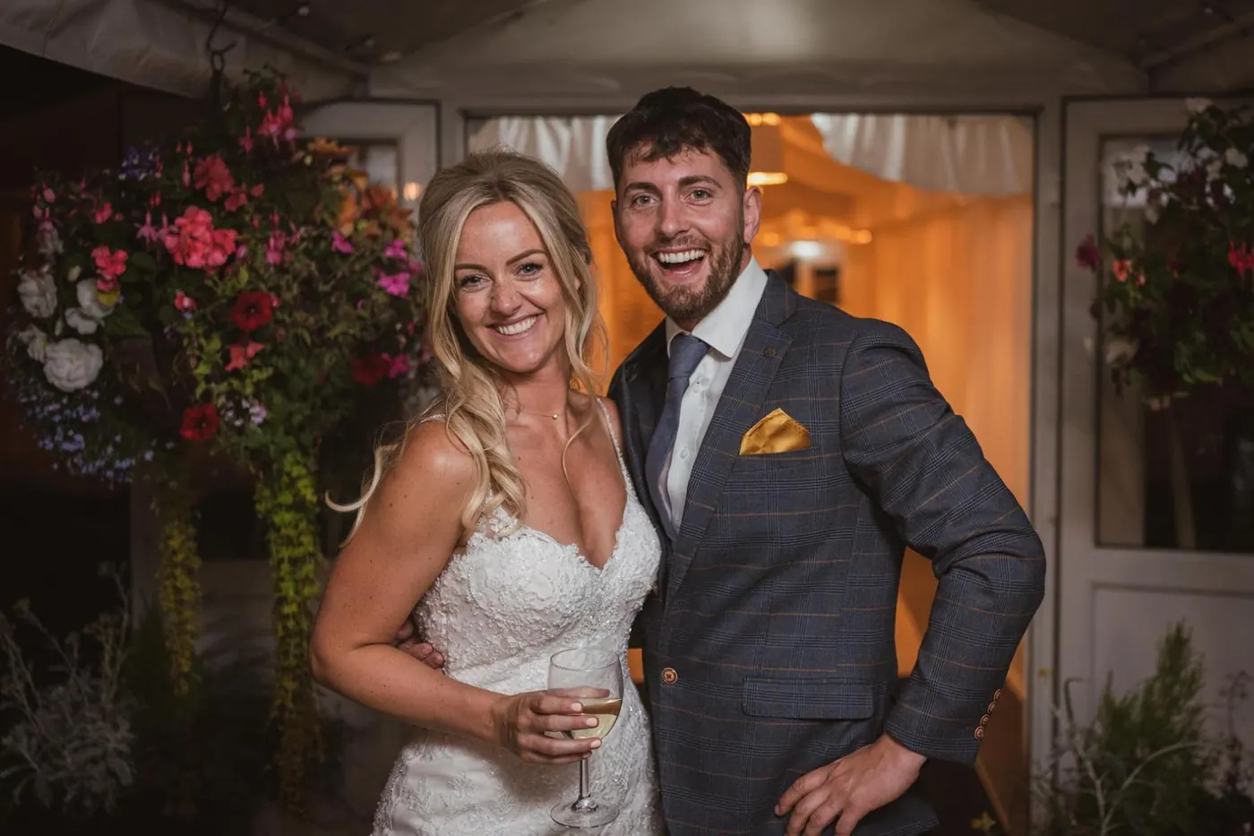 Couple smiling under a floral doorway