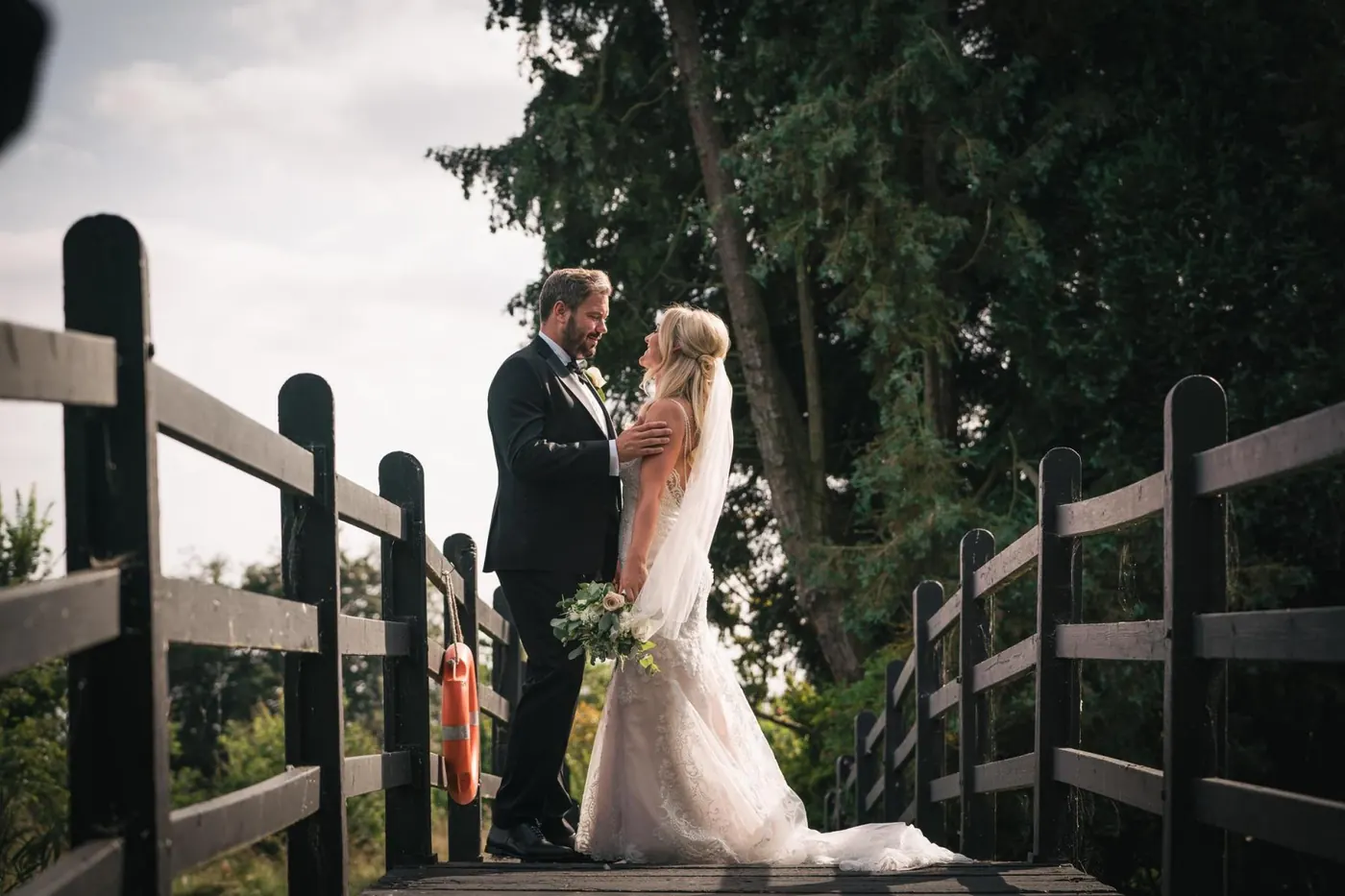 Couple portrait on a wooden bridge in soft evening light