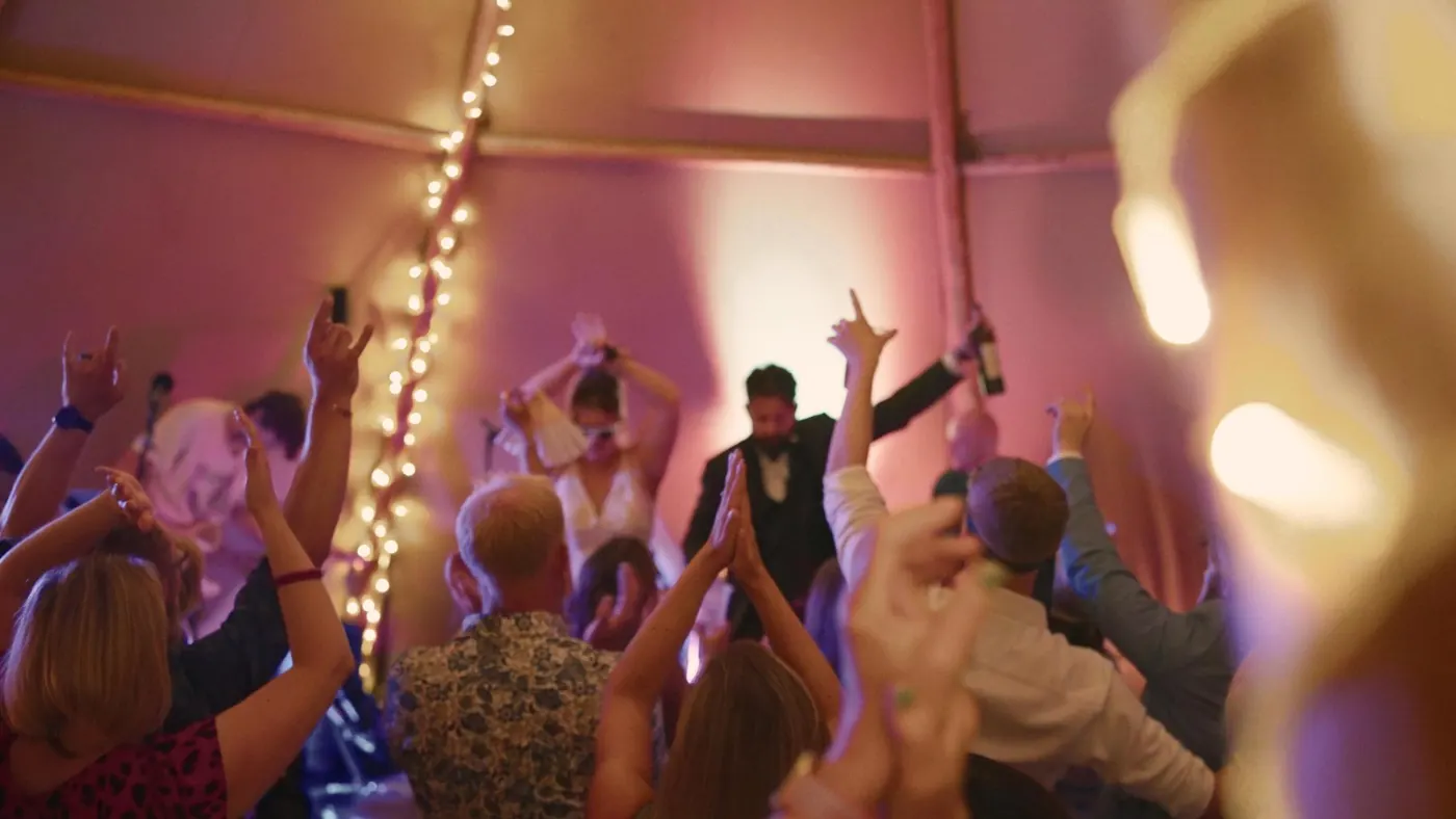 Packed dance floor under festoon lights