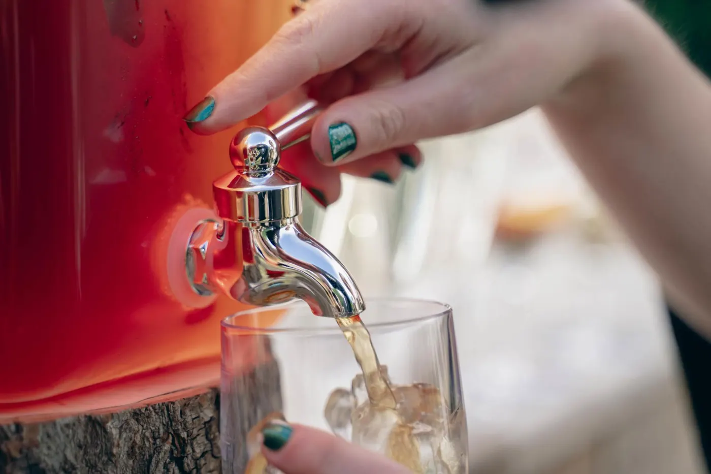 Guest pouring a drink from a dispenser at the drinks reception