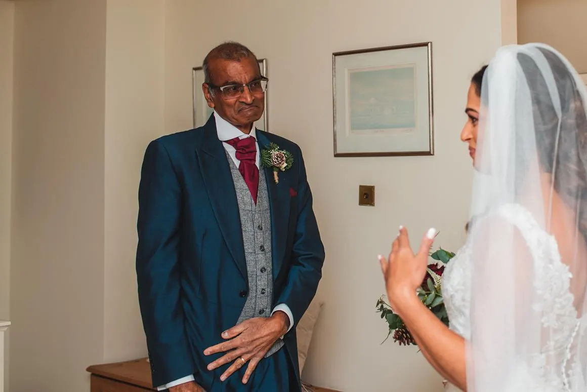 Father of the bride seeing his daughter in her dress for the first time