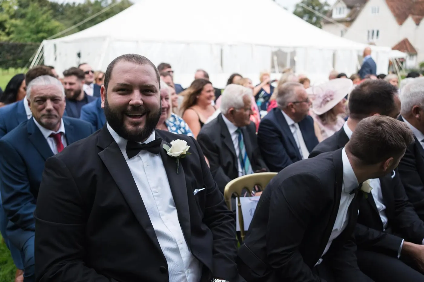 Groom smiling as he waits for the ceremony to begin