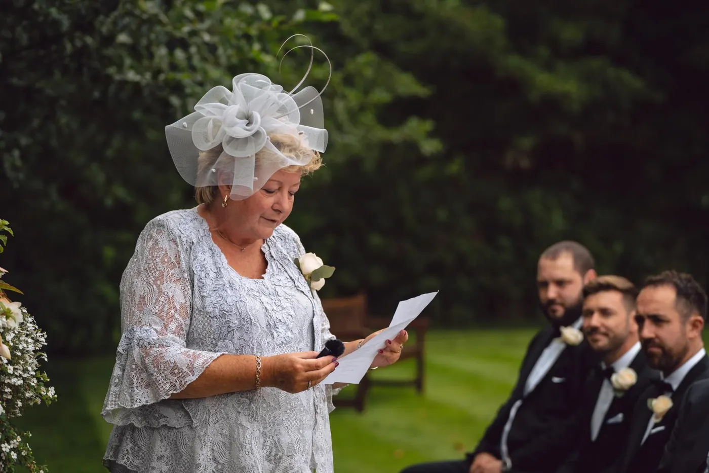 Guest giving a reading at an outdoor ceremony