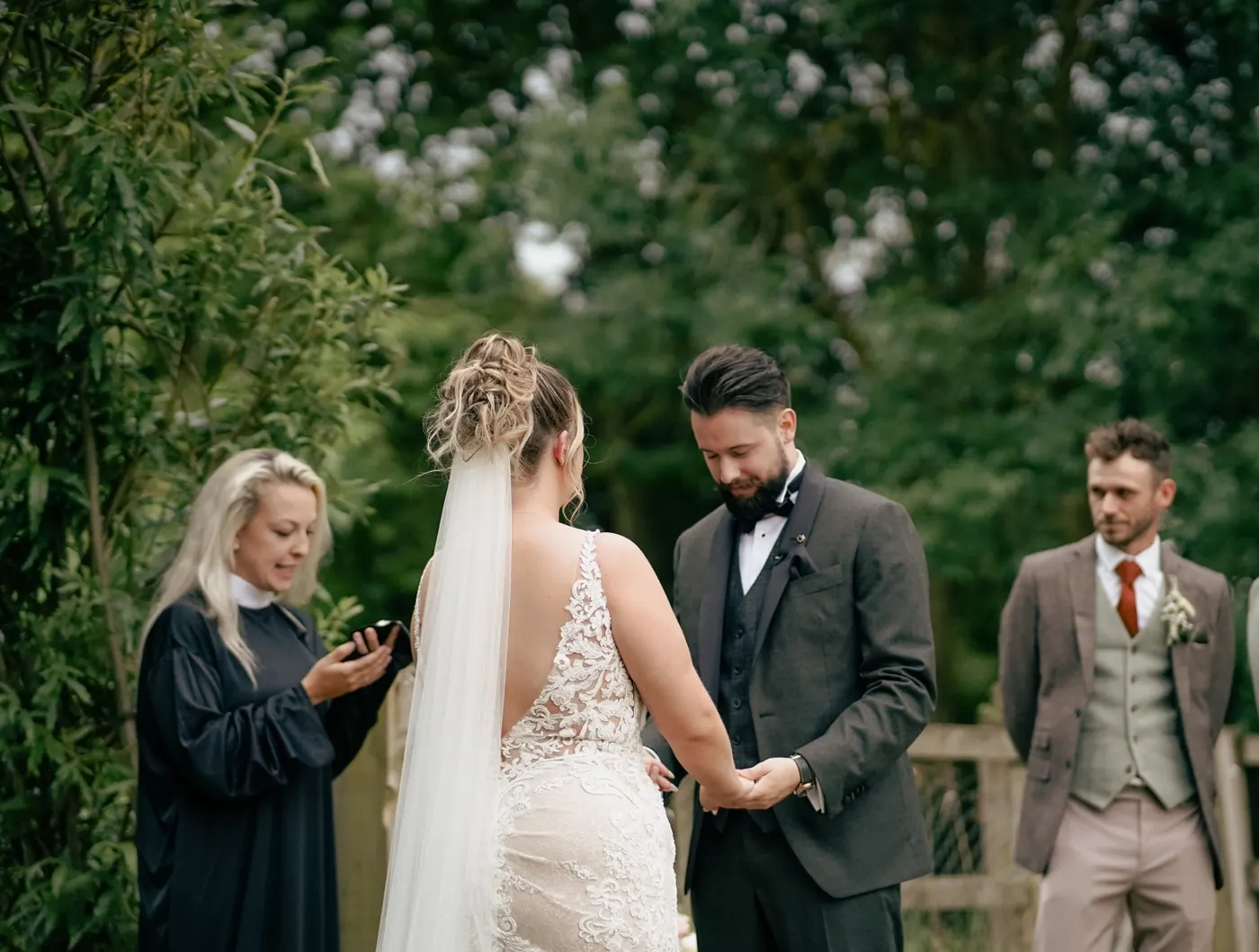 Outdoor wedding ceremony led by a celebrant under the trees