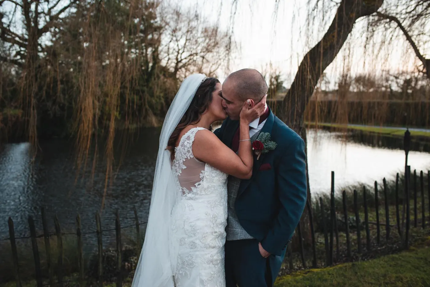 Couple by a river under a weeping willow