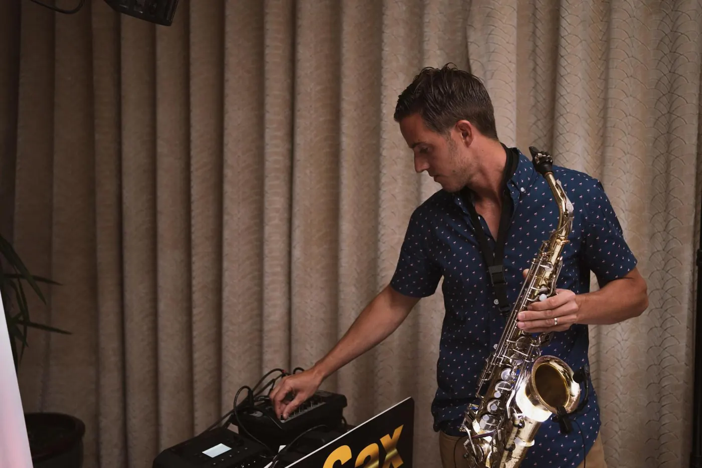 Saxophonist playing alongside the DJ