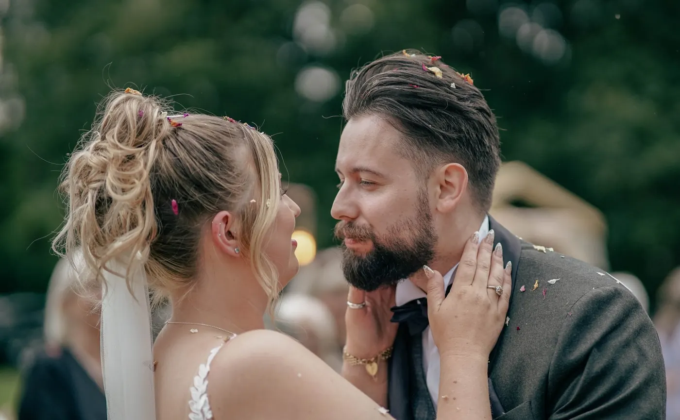 Groom holding the bride's face in a quiet moment after the ceremony