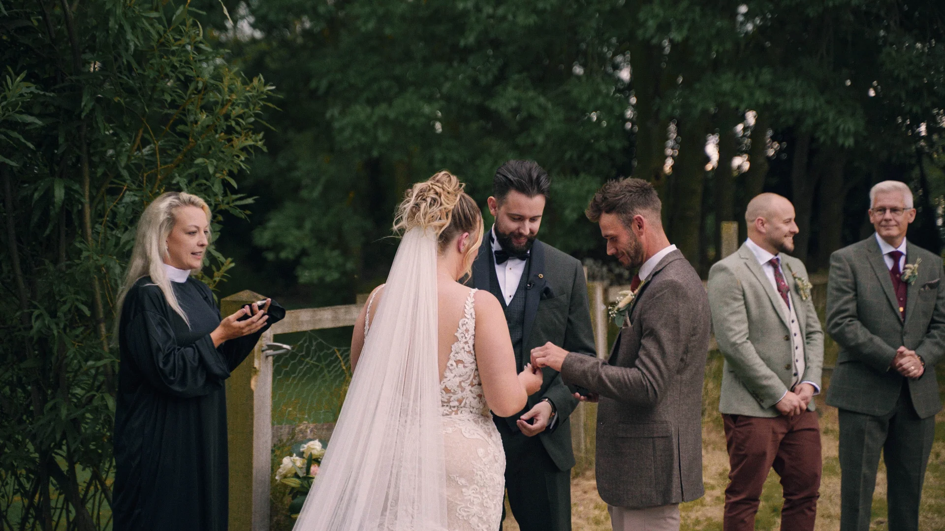 Alice and Alex exchanging vows in the garden