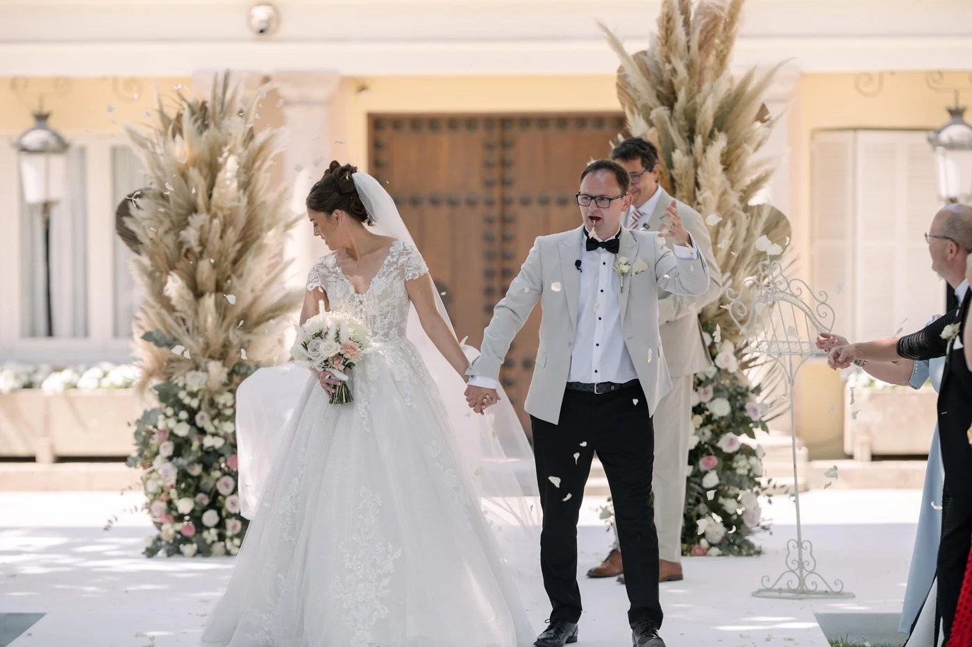 Ellie and Ernie celebrating as they walk away from their outdoor ceremony