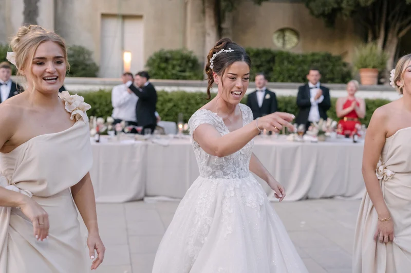 Ellie laughing with a guest during the outdoor wedding celebrations