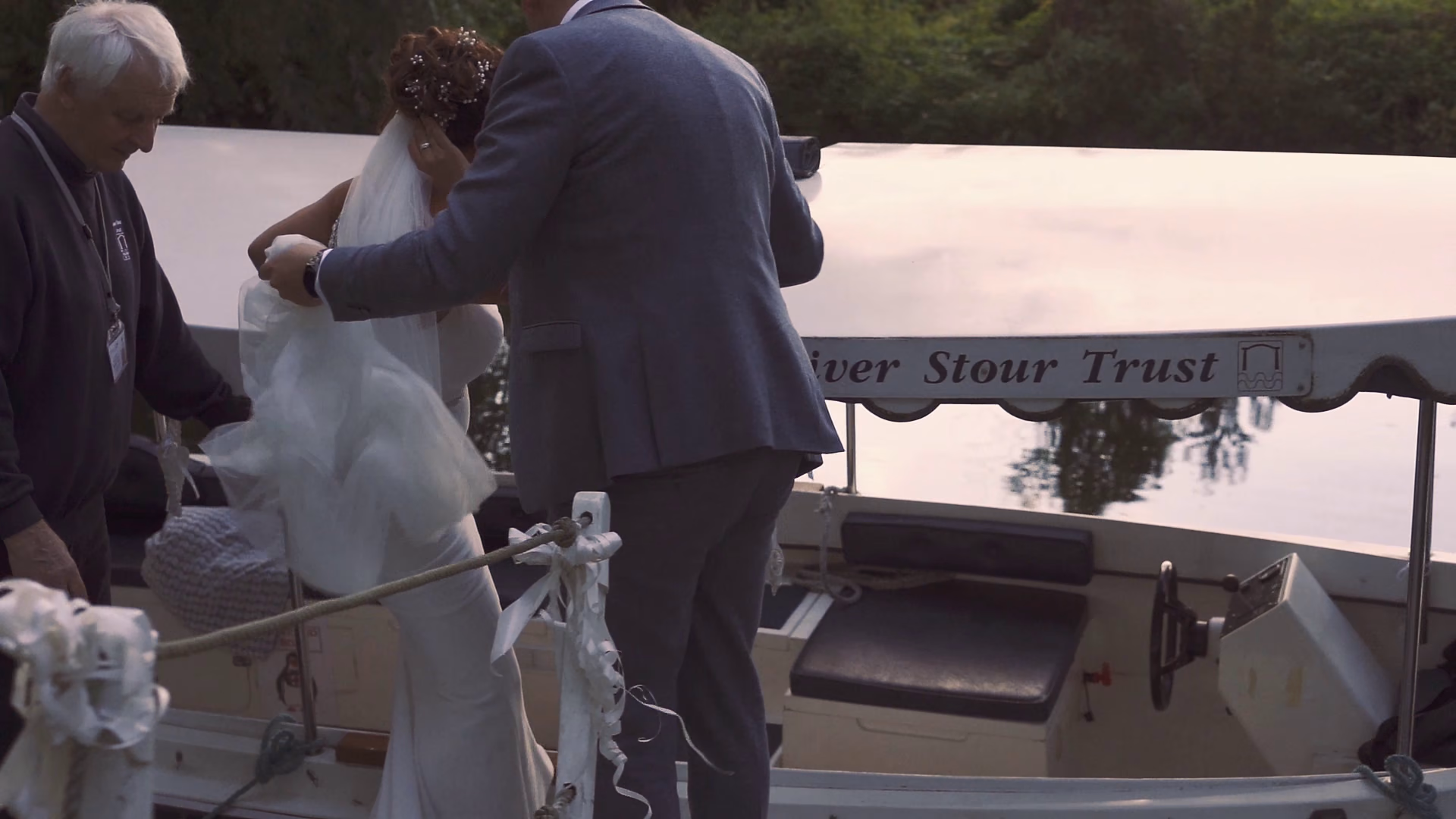 Jo and Andy stepping aboard the boat at Dedham — film still