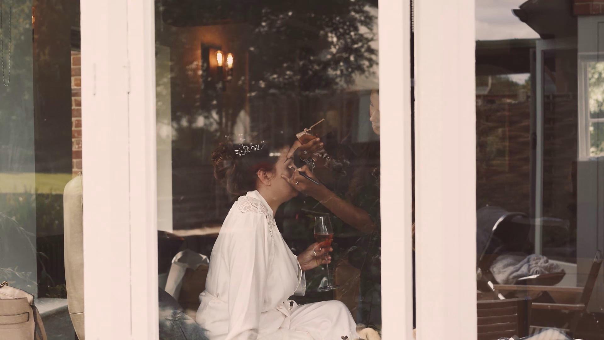 Looking through the window as Jo gets ready — film still