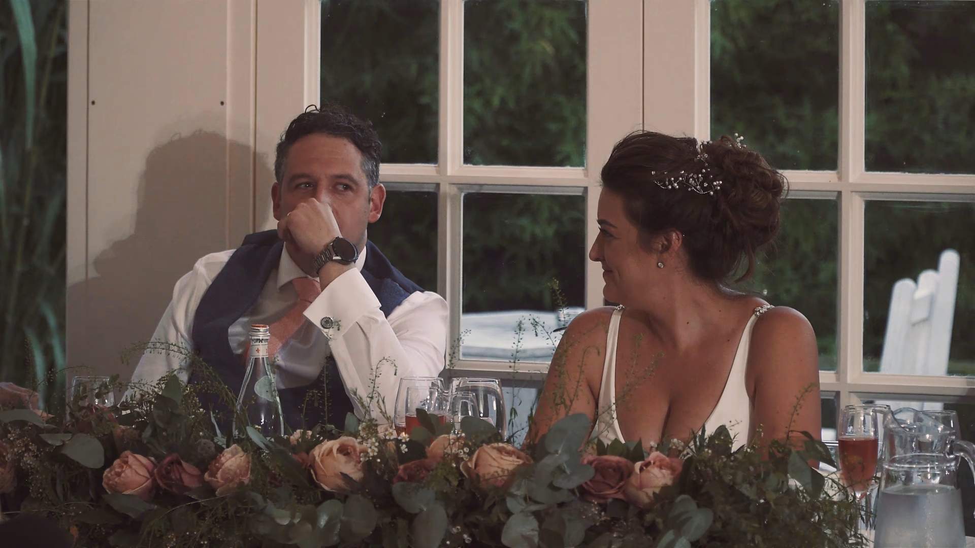 Jo turning towards Andy while they listen to a speech — film still