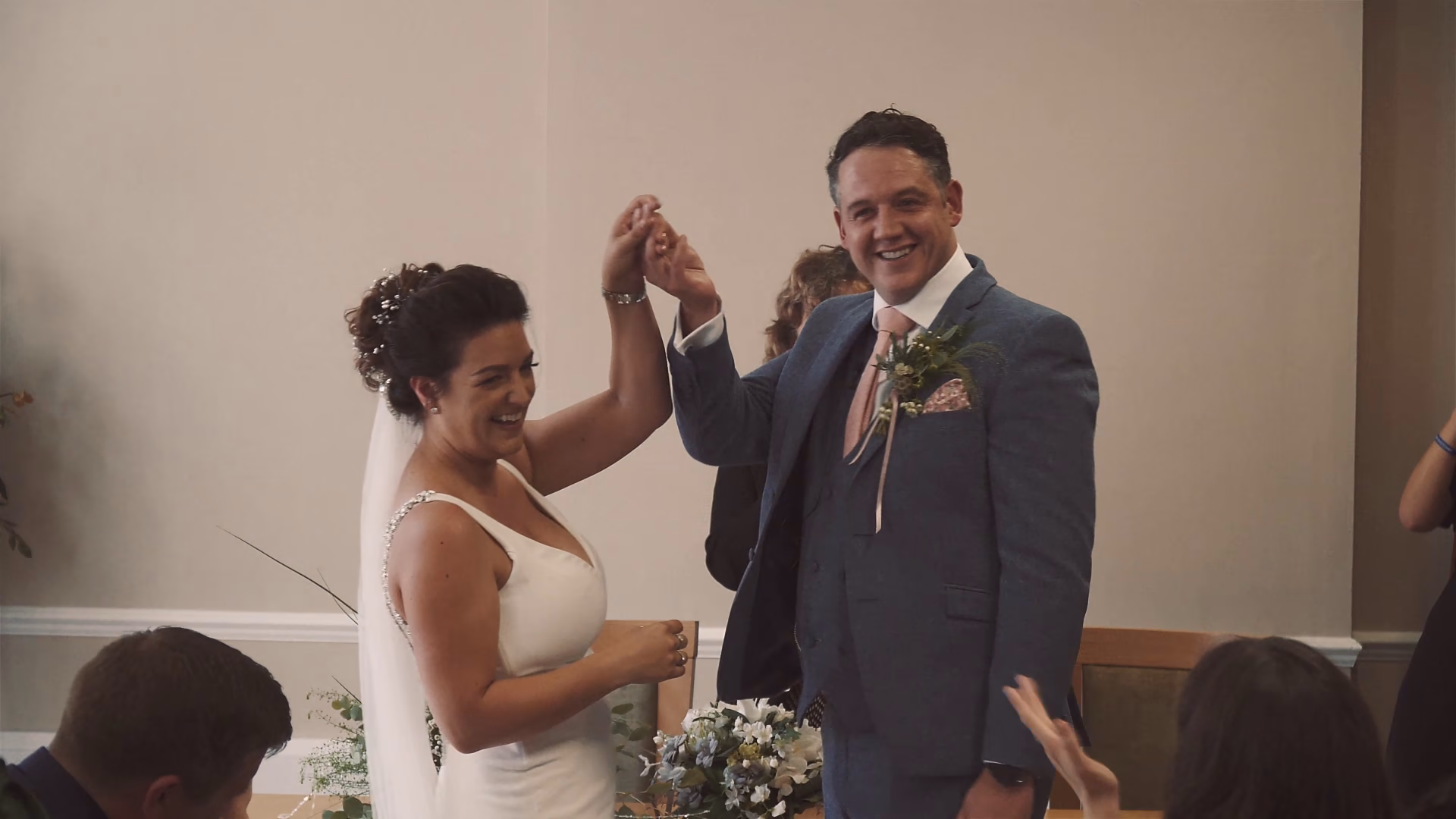 Jo and Andy lifting their hands together at Colchester Town Hall — film still
